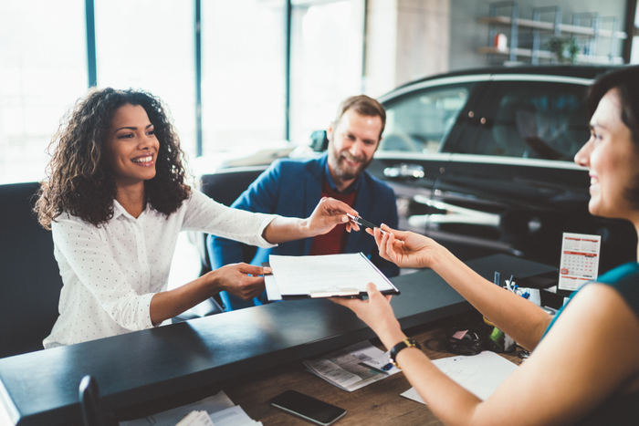 Couple in the showroom buying new car