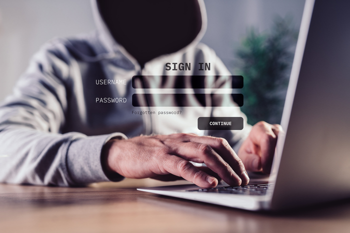 Phishing attack concept, computer hacker using fake website to steal login credentials