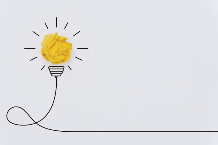 Bulb Concepts with Yellow Crumpled Paper Ball