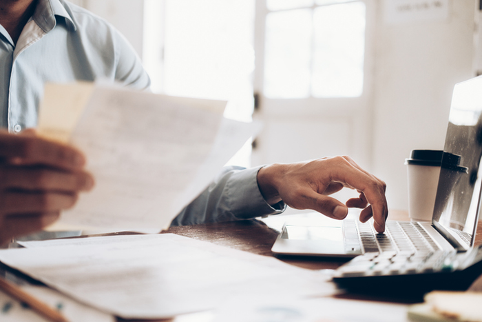 Male accountant or banker use calculator.