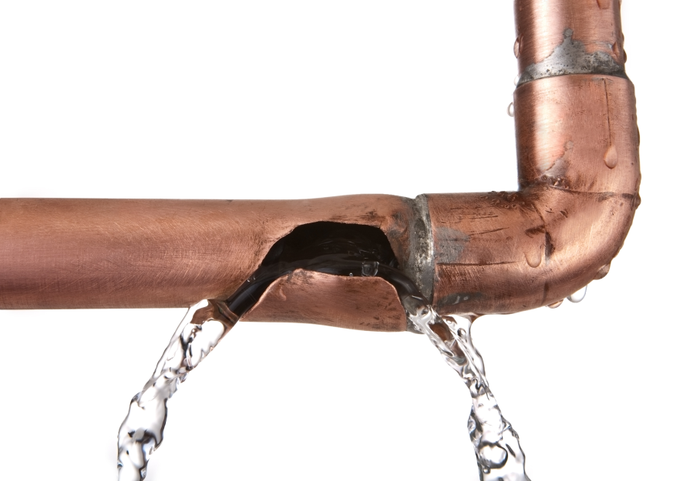broken leaking copper water pipe