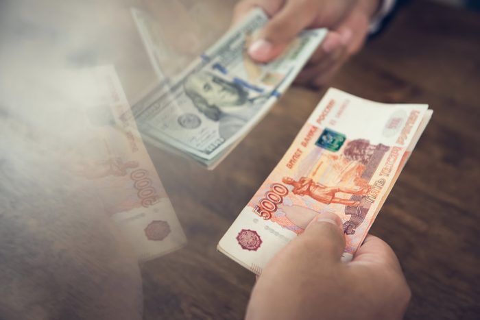 Hand holding US dollar bills trading with Idian Rupee Money