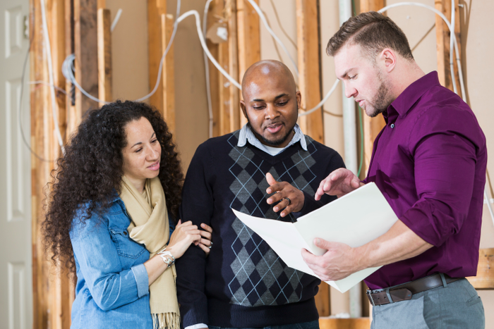 Black couple with contractor remodeling home