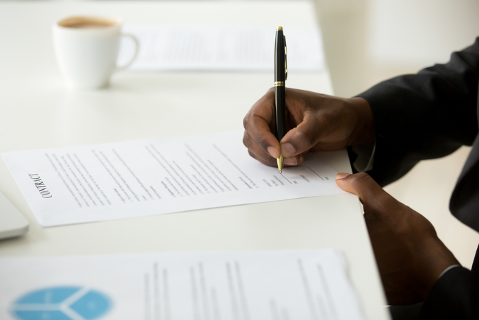 African american man signing a contract