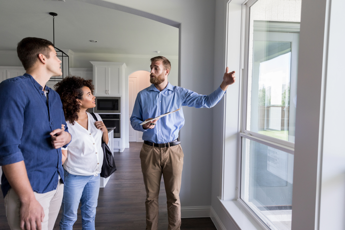 Male real estate agent shows new home