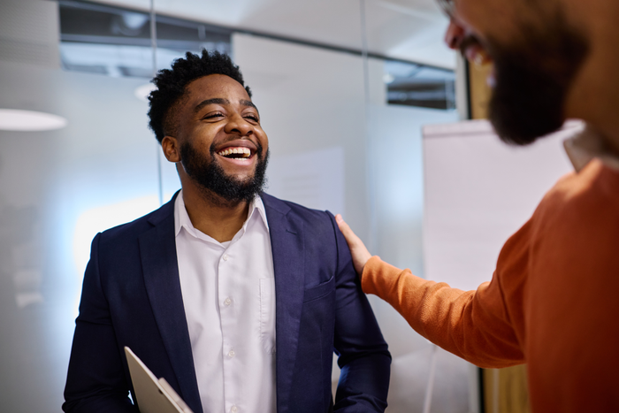 Manager congratulating a happy employee in the office