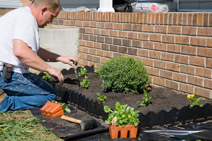 Man planting flowers in garden
