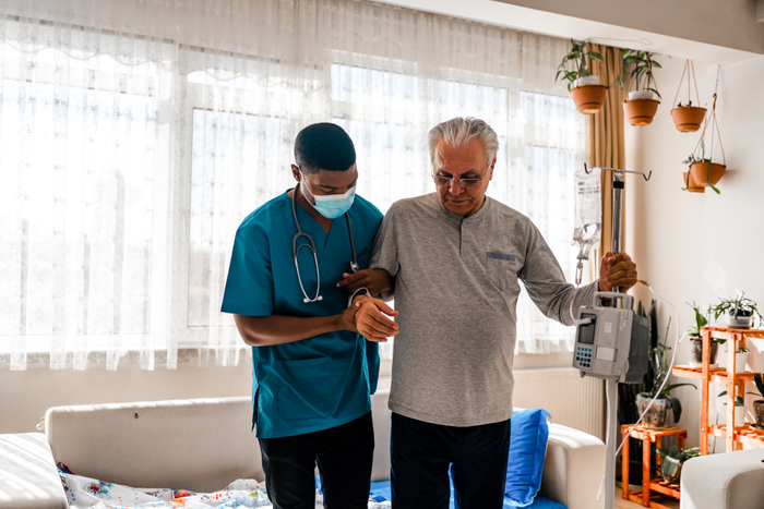 Health visitor and a  man during home visit
